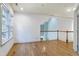 Hardwood floor loft area with stair rail, bright window, and neutral paint at 509 Edgemore Ave, Cary, NC 27519