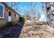 Spacious backyard with a brick patio and a mix of trees, including one leaning strongly at 510 Corrida Ave, Durham, NC 27704