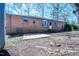 Backyard featuring a brick home, patio, grass area and large trees at 510 Corrida Ave, Durham, NC 27704
