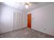 A clean bedroom with plush carpet features a ceiling fan and spacious closet at 510 Corrida Ave, Durham, NC 27704