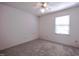 Bedroom with plush carpet, ceiling fan, window with blinds, and electrical outlets at 510 Corrida Ave, Durham, NC 27704