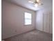 Bedroom with plush carpet, ceiling fan, window with blinds, and closet at 510 Corrida Ave, Durham, NC 27704