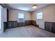 Bedroom with carpet, wood paneling, wallpaper, two windows and an AC unit at 510 Corrida Ave, Durham, NC 27704