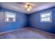 Bedroom with blue wallpaper, two windows and carpet at 510 Corrida Ave, Durham, NC 27704