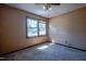 Bright bedroom with two windows and plush carpeting at 510 Corrida Ave, Durham, NC 27704