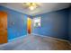 Bedroom with blue wallpaper, window and closet at 510 Corrida Ave, Durham, NC 27704