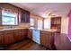 Vintage eat-in kitchen with wooden cabinets, tile countertops, and stainless steel appliances at 510 Corrida Ave, Durham, NC 27704