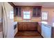 Classic kitchen with wooden cabinets, white appliances, and a cozy window view at 510 Corrida Ave, Durham, NC 27704