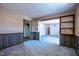 Living room with carpet, wallpaper, wood paneling and multiple entrances at 510 Corrida Ave, Durham, NC 27704