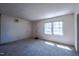 Bright, carpeted living room with a large window and a neutral color palette at 510 Corrida Ave, Durham, NC 27704
