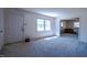 Bright, carpeted living room with a large window and an open doorway to the kitchen at 510 Corrida Ave, Durham, NC 27704