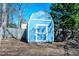 Well maintained blue shed with a white trim located in a spacious backyard at 510 Corrida Ave, Durham, NC 27704