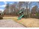 Large fenced backyard featuring a playset and ample space for activities at 5102 Highcroft Dr, Cary, NC 27519