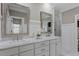 Bathroom with double vanity, marble countertops, and decorative mirrors at 5102 Highcroft Dr, Cary, NC 27519