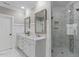 Bathroom features double sinks, white cabinets, tiled shower, and marble countertops at 5102 Highcroft Dr, Cary, NC 27519