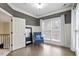 Sitting room with natural light, wood floors, and an accent chair at 5102 Highcroft Dr, Cary, NC 27519