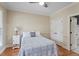 Cozy bedroom features a patterned coverlet, neutral walls, and a ceiling fan at 5102 Highcroft Dr, Cary, NC 27519