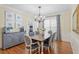 Formal dining room with an elegant chandelier, natural light, and wainscoting along the walls at 5102 Highcroft Dr, Cary, NC 27519