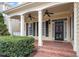 Inviting front porch with brick flooring, white columns, ceiling fans, and an elegant front door at 5102 Highcroft Dr, Cary, NC 27519