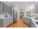 Spacious kitchen with stainless steel appliances, gray cabinetry, a kitchen island, and hardwood flooring at 5102 Highcroft Dr, Cary, NC 27519