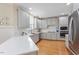 Well-equipped kitchen with stainless steel appliances, stone countertops, and hardwood floors throughout at 5102 Highcroft Dr, Cary, NC 27519