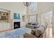 Bright living room with a fireplace, built-in shelving, large windows, and a high ceiling at 5102 Highcroft Dr, Cary, NC 27519