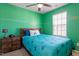 A well lit bedroom featuring bright green walls, a window, and a comfy bed at 515 Autumn Cure Ct, Fuquay Varina, NC 27526