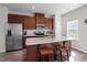 A modern kitchen with stainless steel appliances and a granite countertop island with seating at 515 Autumn Cure Ct, Fuquay Varina, NC 27526