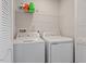 Convenient laundry room with washer, dryer, and overhead shelving at 515 Autumn Cure Ct, Fuquay Varina, NC 27526
