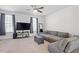 Comfortable living room with a ceiling fan, large sectional, and media console at 515 Autumn Cure Ct, Fuquay Varina, NC 27526