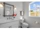 Stylish bathroom features a modern vanity, framed mirror, and a window for natural light at 517 Coleman St, Raleigh, NC 27610