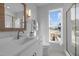 Bright bathroom with white marble surfaces, framed mirror, and glass shower enclosure at 517 Coleman St, Raleigh, NC 27610