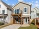Charming two-story home features a balcony and inviting ground-floor patio area at 517 Coleman St, Raleigh, NC 27610