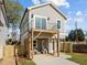 Modern two-story home features a balcony, ground-floor patio, and fenced yard at 517 Coleman St, Raleigh, NC 27610