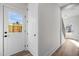 Bright hallway with wood floors leads to a door with a window and a staircase at 517 Coleman St, Raleigh, NC 27610