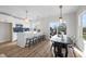 Well-lit kitchen with breakfast bar and dining area, featuring a view of the outdoor balcony at 517 Coleman St, Raleigh, NC 27610