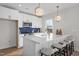 Spacious kitchen island with seating, stainless appliances, and white cabinetry creates a modern and functional space at 517 Coleman St, Raleigh, NC 27610