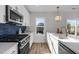 Stylish kitchen showcasing stainless steel appliances, modern white countertops, and blue backsplash at 517 Coleman St, Raleigh, NC 27610