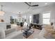 Bright and airy living room featuring modern decor, hardwood floors, and large windows at 517 Coleman St, Raleigh, NC 27610