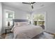 Bright main bedroom features a ceiling fan and sliding door to the outdoor deck at 517 Coleman St, Raleigh, NC 27610