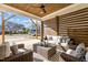 Inviting covered patio featuring stylish outdoor furniture and a ceiling fan for comfort at 517 Coleman St, Raleigh, NC 27610