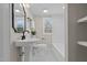 Charming bathroom featuring pedestal sink, black and white tile, and a bathtub at 518 W Chisholm St, Sanford, NC 27330