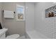 Bathroom features subway tile, a built-in storage niche, and tiled floors at 518 W Chisholm St, Sanford, NC 27330