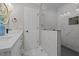 Stylish bathroom boasts a tiled walk-in shower with glass door, a modern vanity, and elegant lighting at 518 W Chisholm St, Sanford, NC 27330