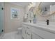 Bright bathroom featuring double vanity, marble countertops, round mirrors and a window at 518 W Chisholm St, Sanford, NC 27330