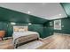 Comfortable bedroom with hardwood floors, accent walls, and natural lighting at 518 W Chisholm St, Sanford, NC 27330