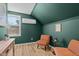 Cozy bedroom space featuring wood floors, accent walls, and inviting sitting area at 518 W Chisholm St, Sanford, NC 27330