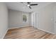 Neutral bedroom featuring a ceiling fan, hardwood floors, a window, and a closet at 518 W Chisholm St, Sanford, NC 27330