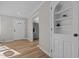 Bright entryway with hardwood floors, built in shelving, and views to the kitchen at 518 W Chisholm St, Sanford, NC 27330