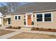 Charming home exterior with orange front door, covered porch, and manicured garden at 518 W Chisholm St, Sanford, NC 27330